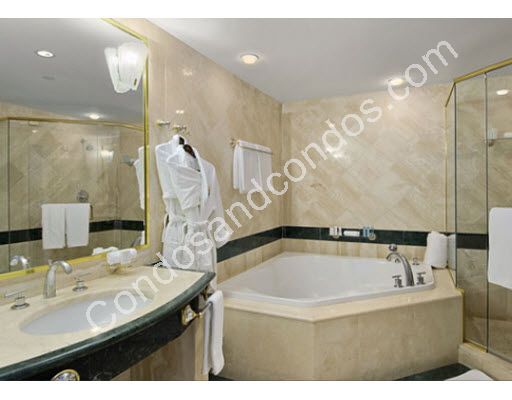 Jacuzzi tub and enclosed glass shower in master bath