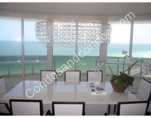 Oceanfront dining room and designer light fixture 