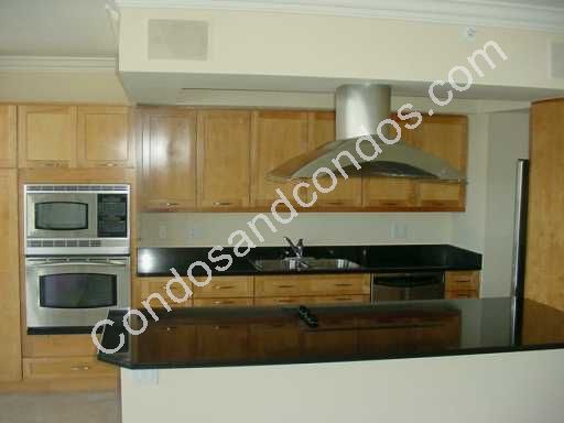 Kitchen including cook-top island and range hood