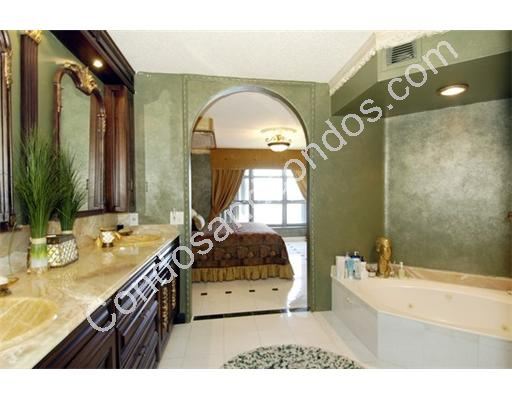 Spacious master bath with jacuzzi tub and marble surfaces