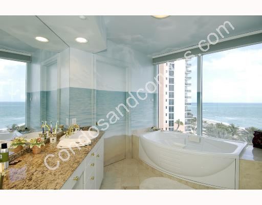 Master bath with marble surfaces and ocean backdrop
