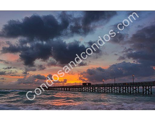 Surf lapping against the pier and sunset