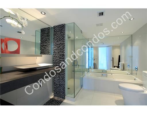 Master bath with enclosed glass shower & separate Jacuzzi tub
