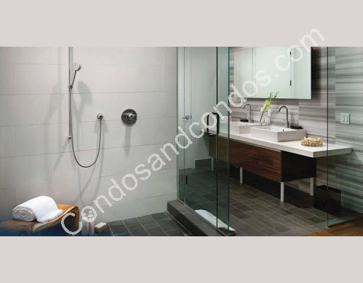 Spacious baths w/ custom vanities & oversized glass enclosed framless showers 