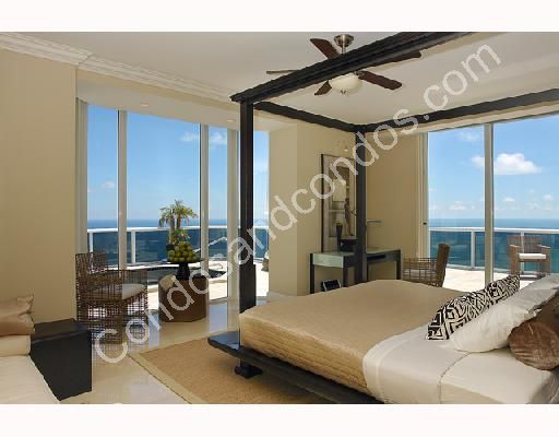 Master suite with ceiling fan and private balcony