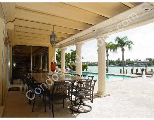 Spacious patio looks out to pool and Biscayne Bay