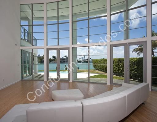 Floor to ceiling glass leads out to pool and docks