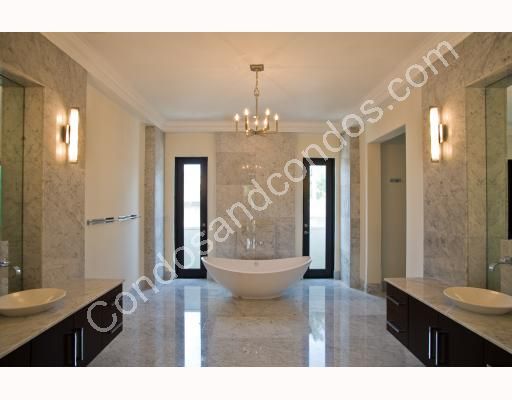 Oversized master bath with rich marble floors and soaking tub