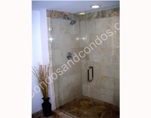 Large glass shower with ceramic tile