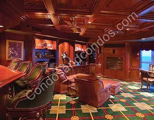 Opulent media room with sit in bar and ceiling fan