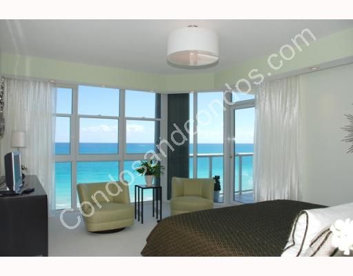 Master bedroom with pricate balcony overlooking the ocean