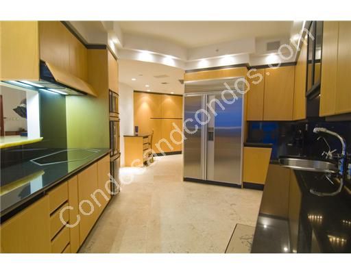 Kitchen includes granite counter-tops and glass cook-top