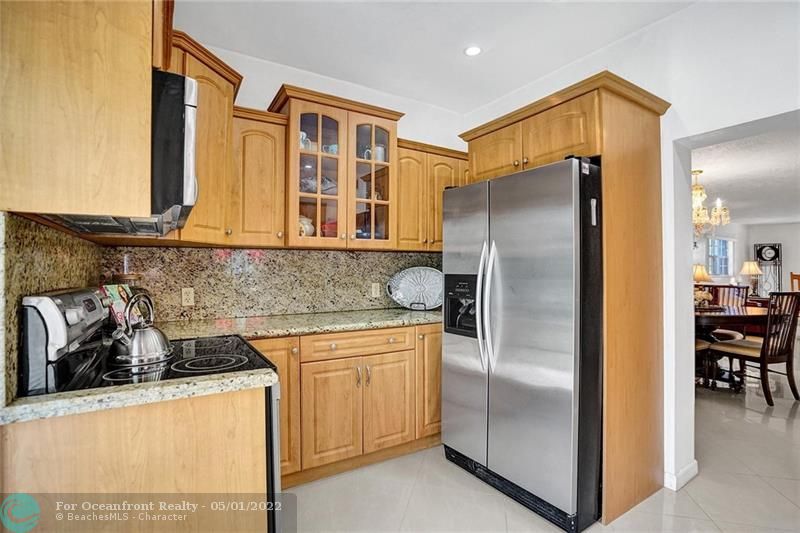 Kitchen has granite counters and stainless appliances.