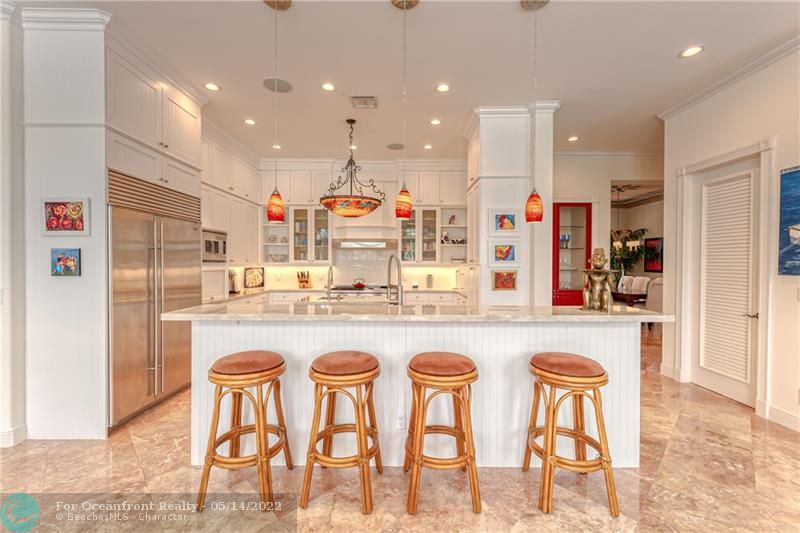 Large center island with breakfast bar in kitchen
