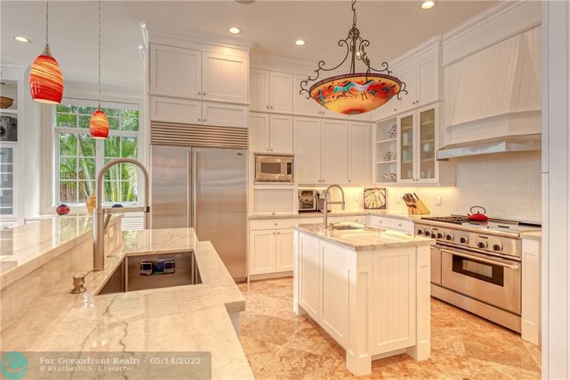 Floor to ceiling white cabinets offers tons of storage space