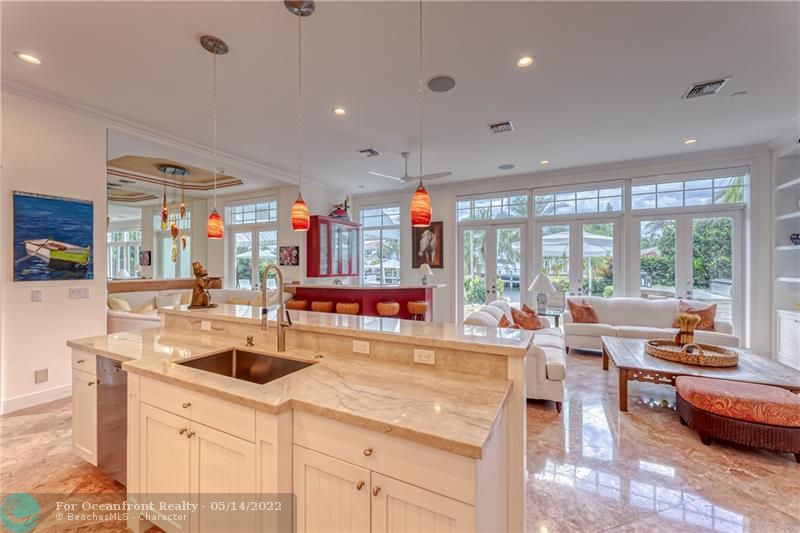 Kitchen opens into large and spacious family room and bar area with water views