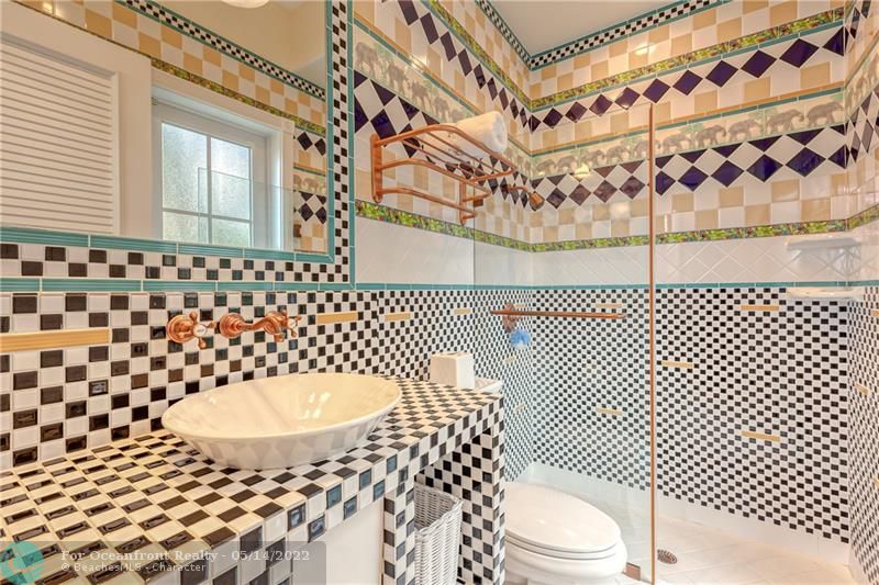 Custom Tile work in this cabana bathroom that leads to pool area
