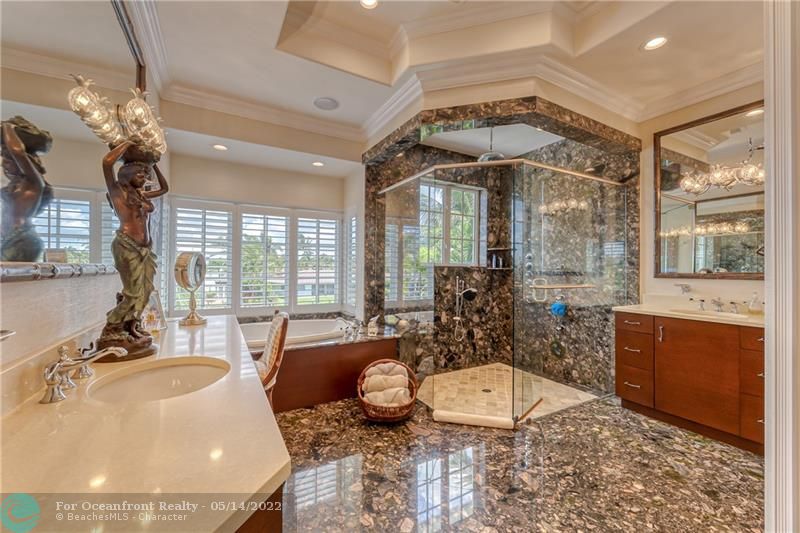 Custom marble bathroom in master with double vanities, walk in shower and Kohler jetted tub