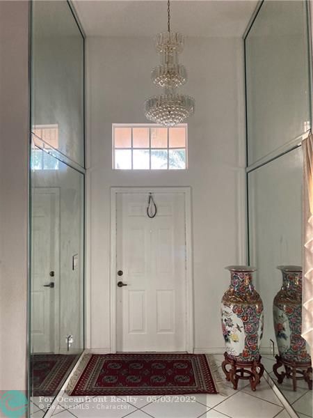 Front door entry. Dramatic custom designed mirror from floor to ceiling.