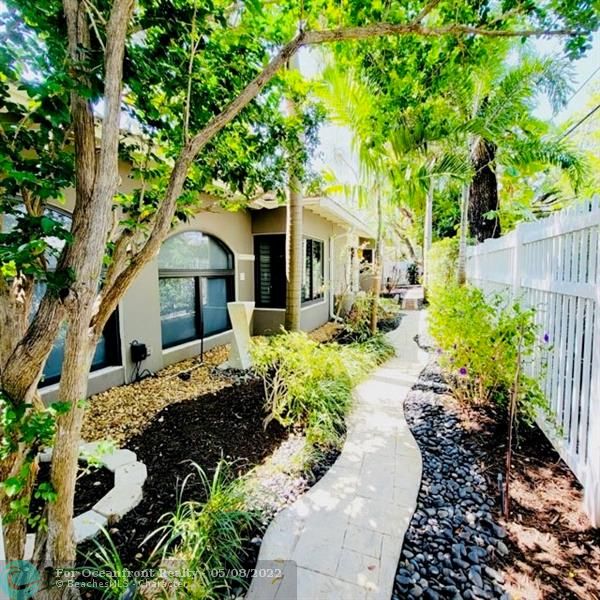 Beautifully landscaped fenced walkway to the front door
