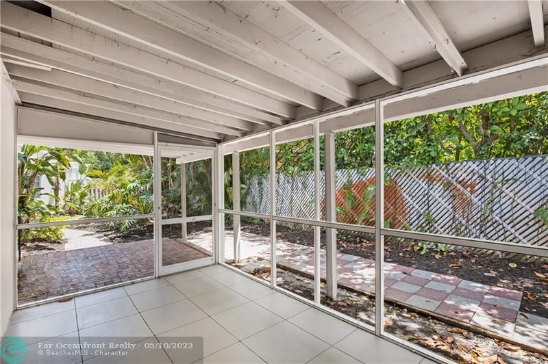Guest house has sliding doors opening to a large screened patio