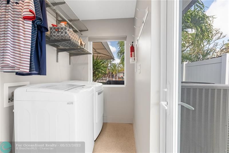 Large bright laundry room with storage