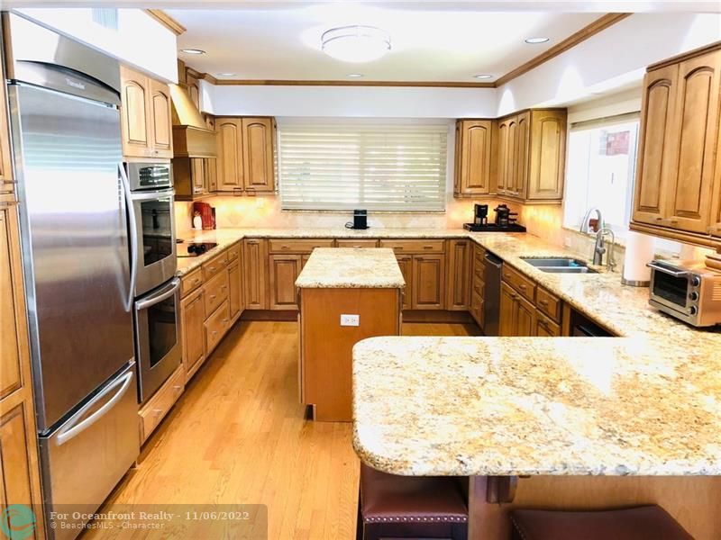 Custom designed kitchen with high end appliances, dual ovens, Kraft Maid cabinetry and granite countertops