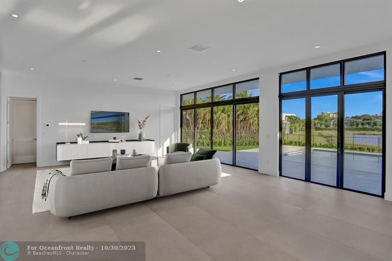 Floor to ceiling glass windows line the entire Family Room, Dining and Kitchen. Virtually Staged